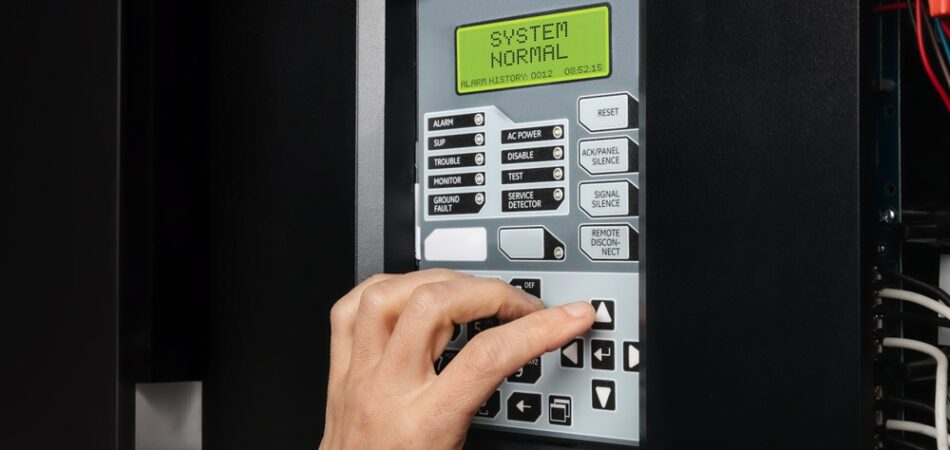 Technician,using,fire,alarm,control,panel,in,service,room.,single Stage